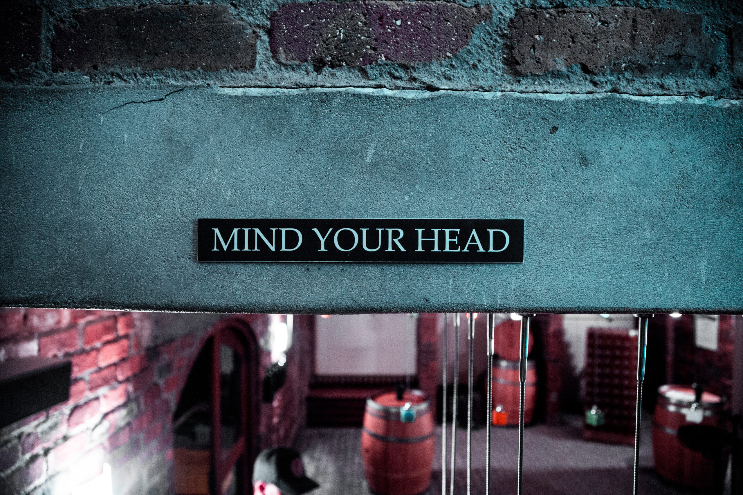 A mind your head sign on a low beam